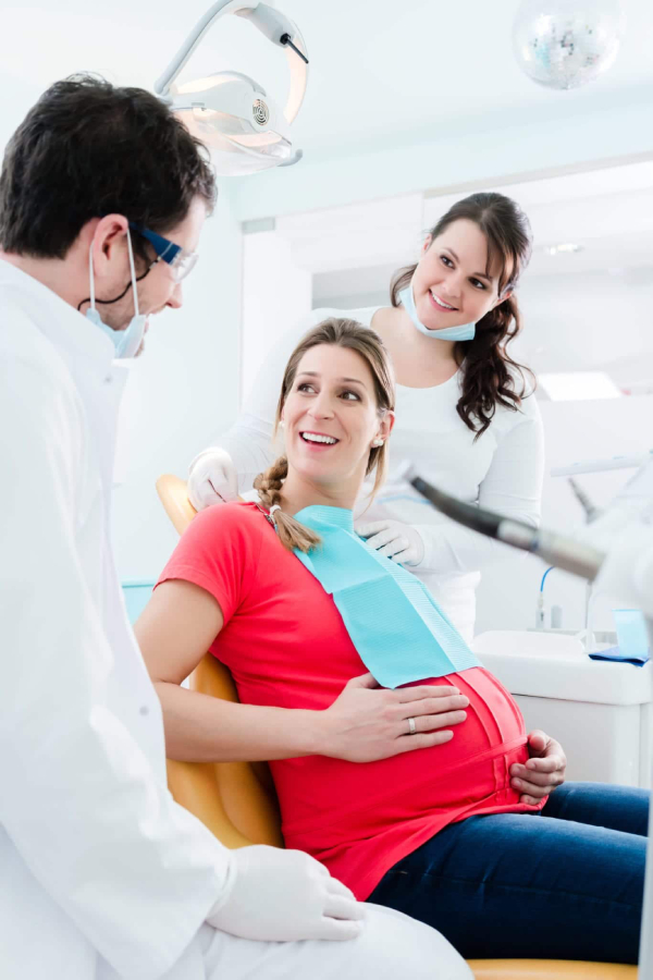 Pregnant woman smiling, representing maternal oral health